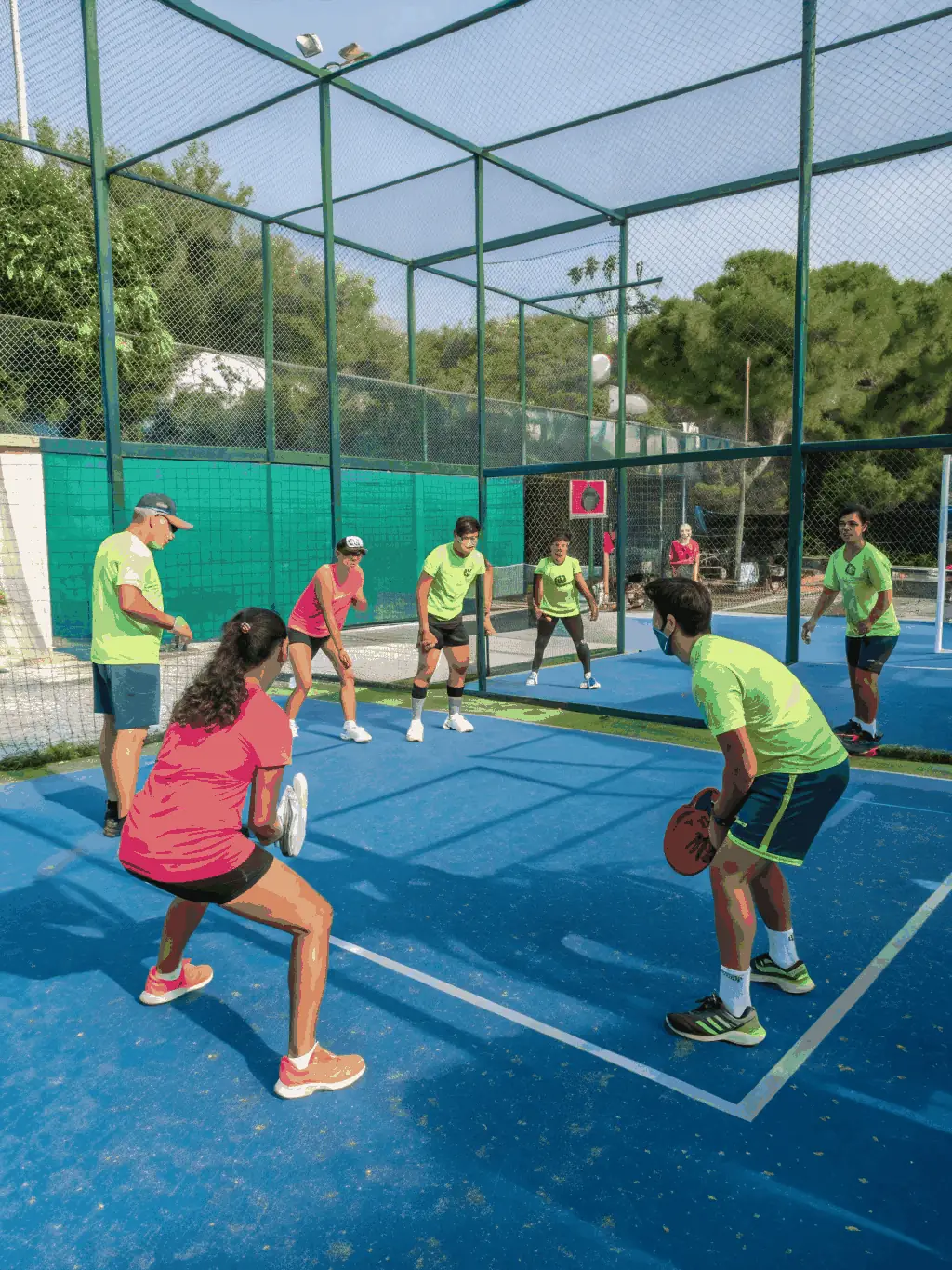 An energetic image of players rallying on a padel court, emphasizing teamwork and enjoyment.